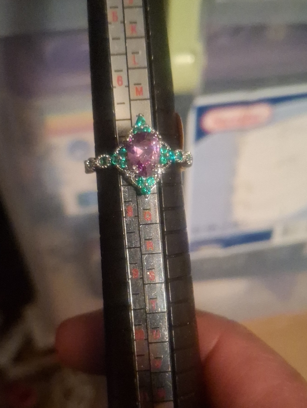 Silver Toned Ring with Purple Center Stone and Green Accents